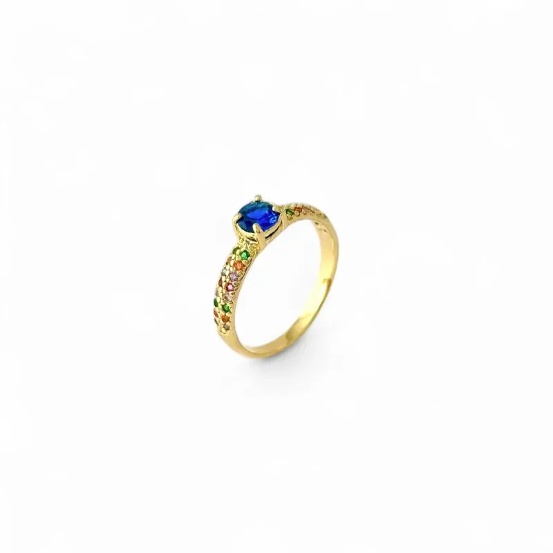 Anel Estilo Solitário Banhado a Ouro 18k com Zircônia Azul e Aro Cravejado com Zircônias Coloridas Anel Estilo Solitário Banhado a Ouro 18k com Zircônia Azul e Aro Cravejado com Zircônias Coloridas